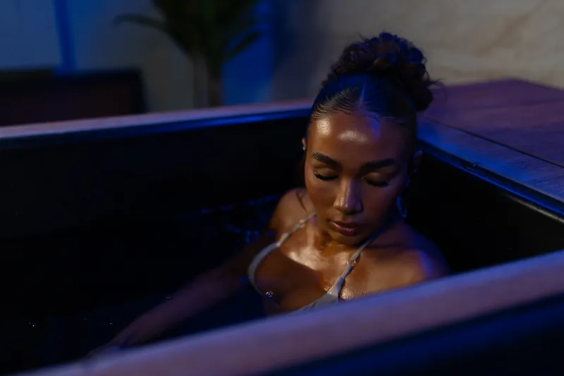Guest resting in the cold plunge tub
